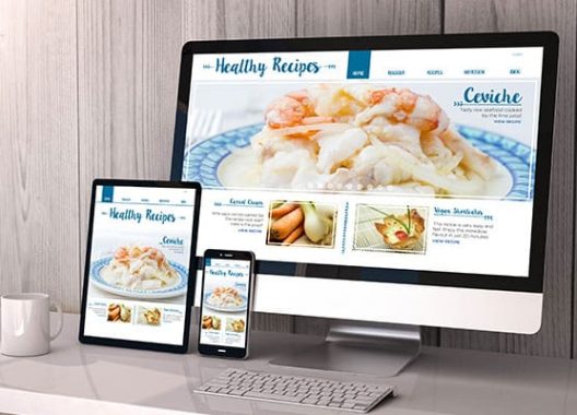 Desktop, tablet and mobile phone opening a website showing mobile responsive